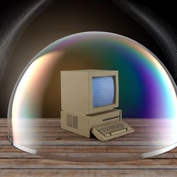 A digital shield surrounds a computer, symbolizing